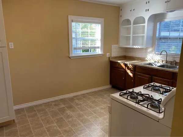 a kitchen with granite countertop a stove and a sink