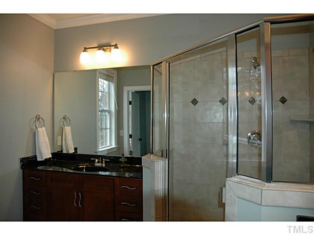 9312 Tabriz Point Raleigh, NC 27614 - Photo 10 of 25 His and hers sink flank the shower.