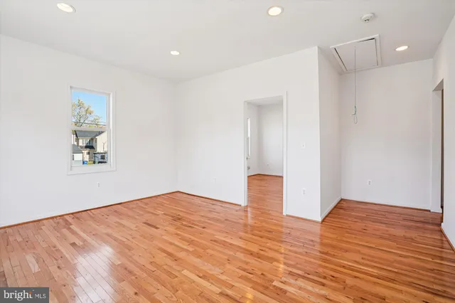 a view of empty room with wooden floor
