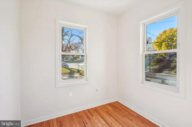 a view of empty room with window and wall painting