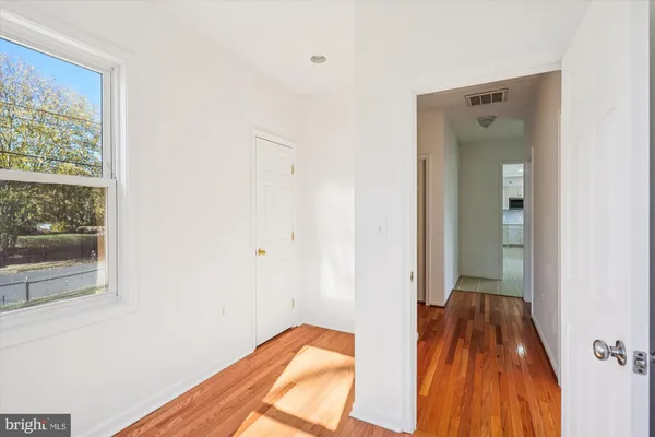 a room with wooden floor and shoes