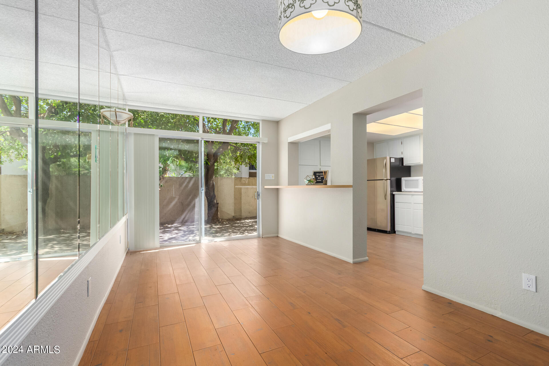 4201 East Camelback Road, Unit 35 Phoenix, AZ 85018 - Photo 14 of 33 a view of a kitchen with wooden floor and a window