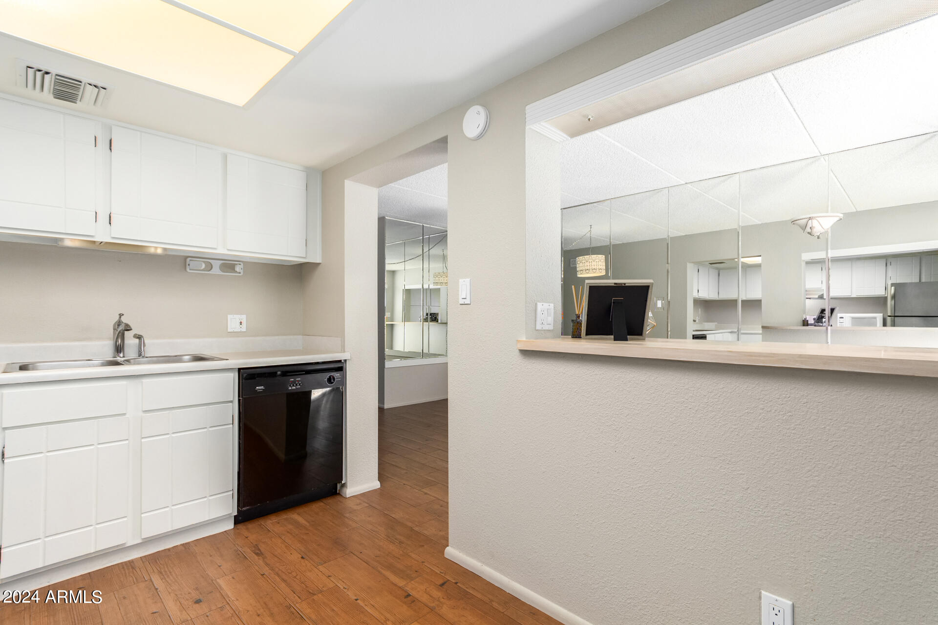 4201 East Camelback Road, Unit 35 Phoenix, AZ 85018 - Photo 18 of 33 a kitchen with granite countertop a sink and cabinets