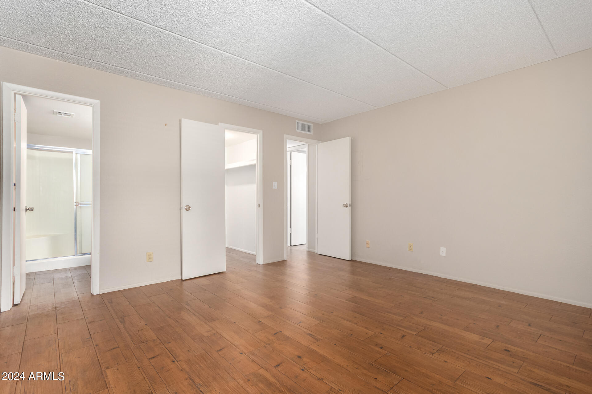 4201 East Camelback Road, Unit 35 Phoenix, AZ 85018 - Photo 21 of 33 a view of an empty room and wooden floor