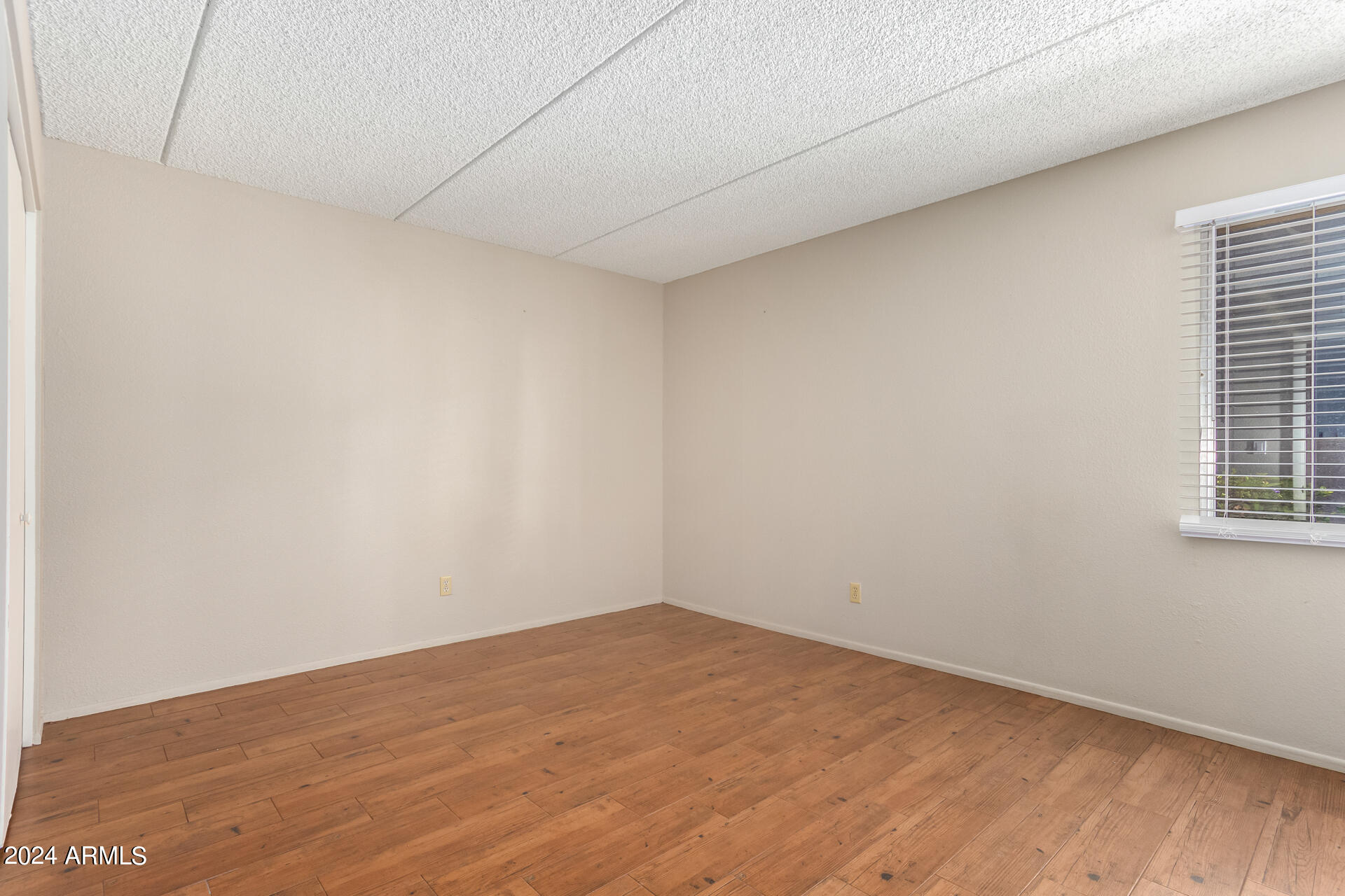 4201 East Camelback Road, Unit 35 Phoenix, AZ 85018 - Photo 24 of 33 a view of empty room with wooden floor