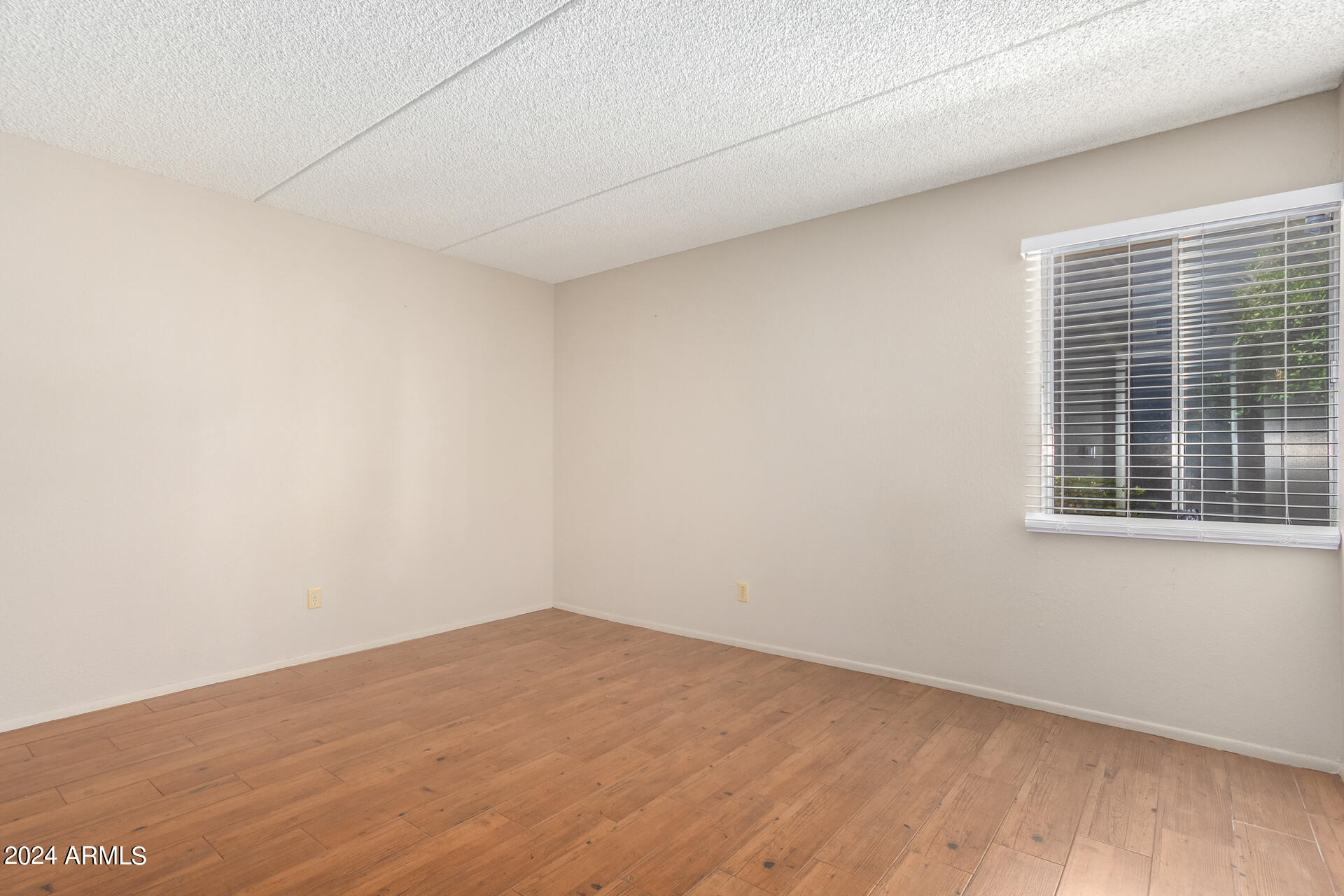 4201 East Camelback Road, Unit 35 Phoenix, AZ 85018 - Photo 25 of 33 a view of empty room with wooden floor