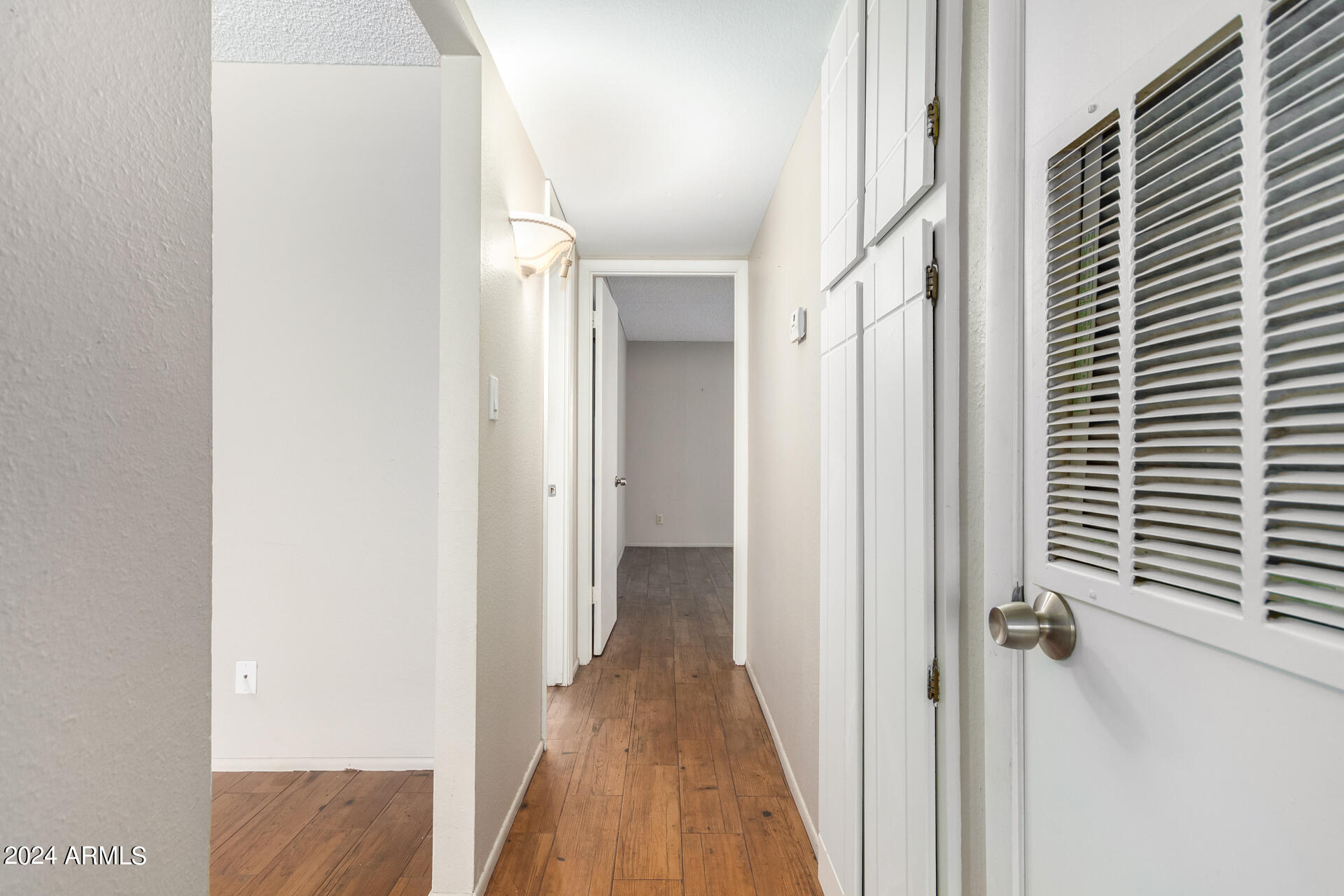 4201 East Camelback Road, Unit 35 Phoenix, AZ 85018 - Photo 28 of 33 a view of a hallway with a wooden door
