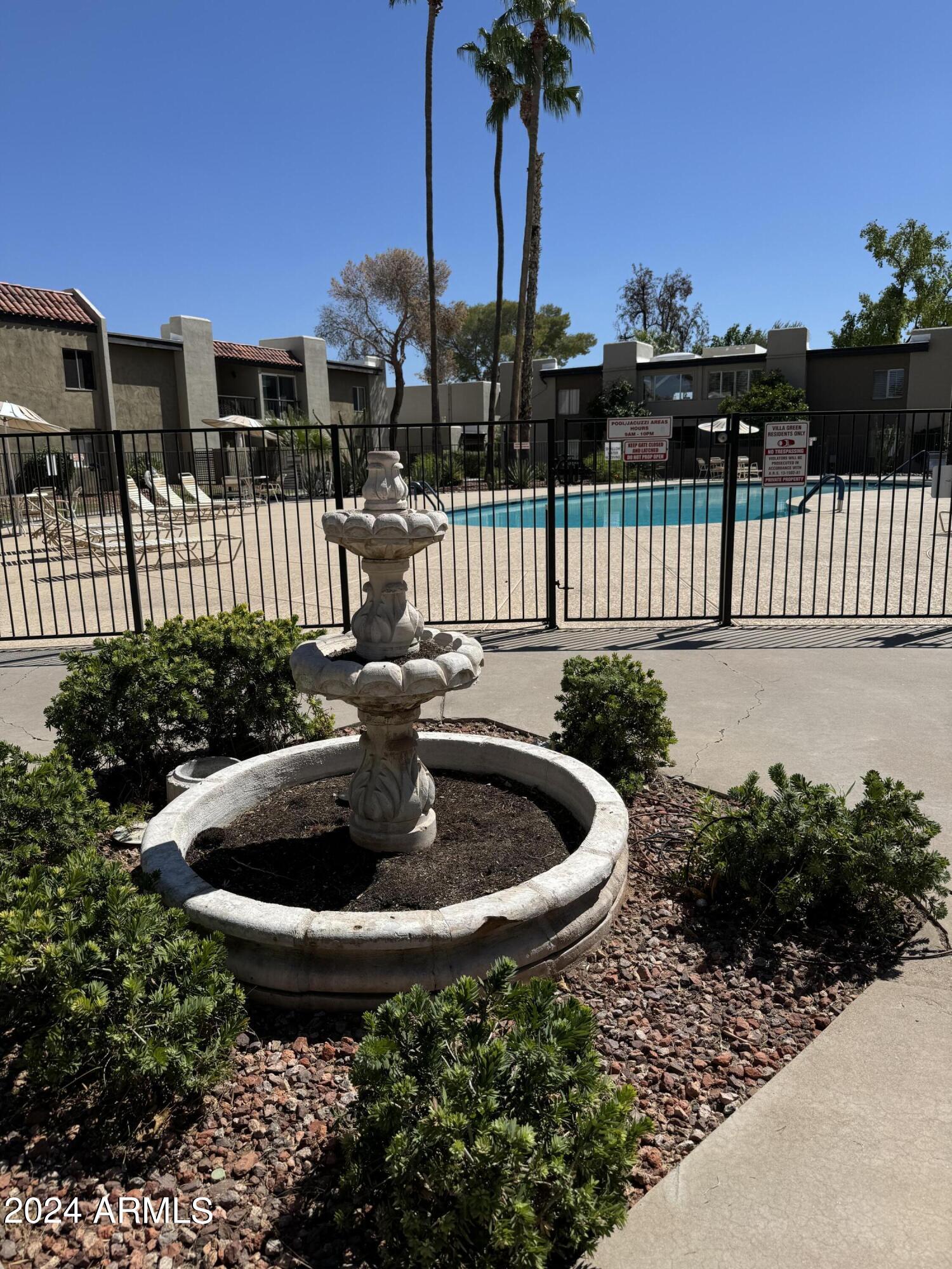 4201 East Camelback Road, Unit 35 Phoenix, AZ 85018 - Photo 30 of 33 a view of a garden with a small pool
