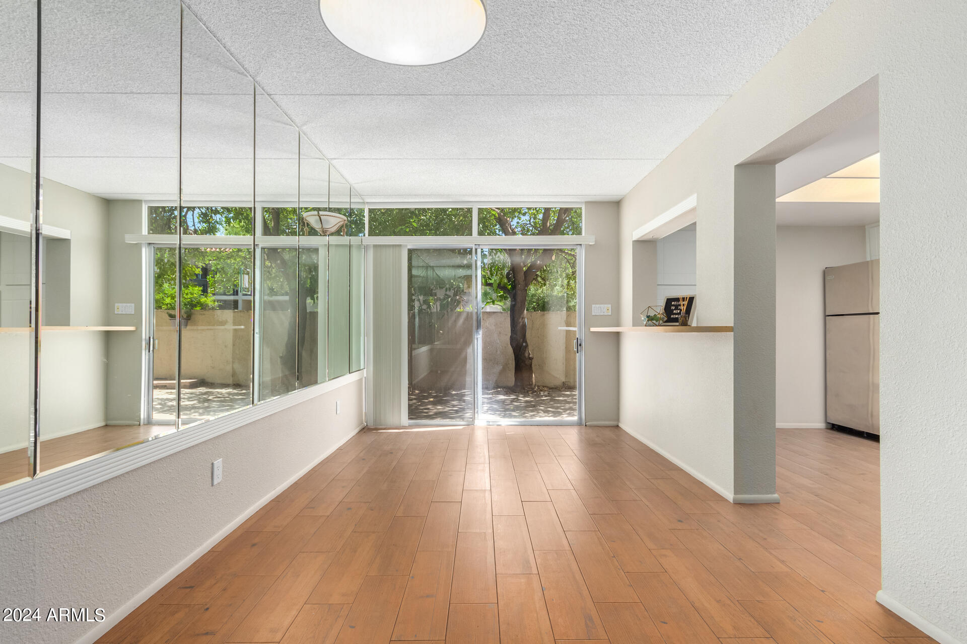 4201 East Camelback Road, Unit 35 Phoenix, AZ 85018 - Photo 3 of 33 a view of a room with wooden floor and a window