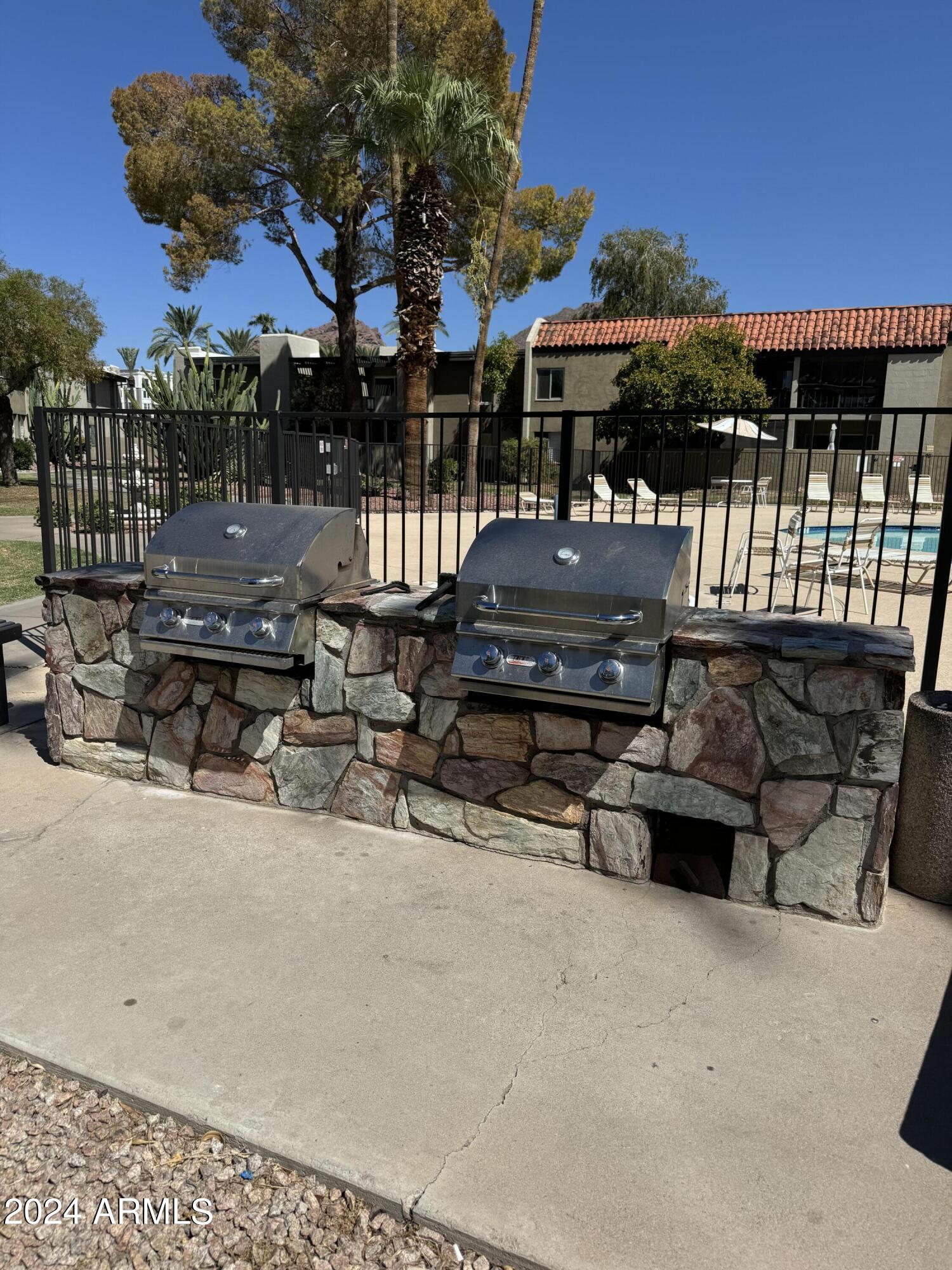 4201 East Camelback Road, Unit 35 Phoenix, AZ 85018 - Photo 32 of 33 a view of a chairs and tables in the patio