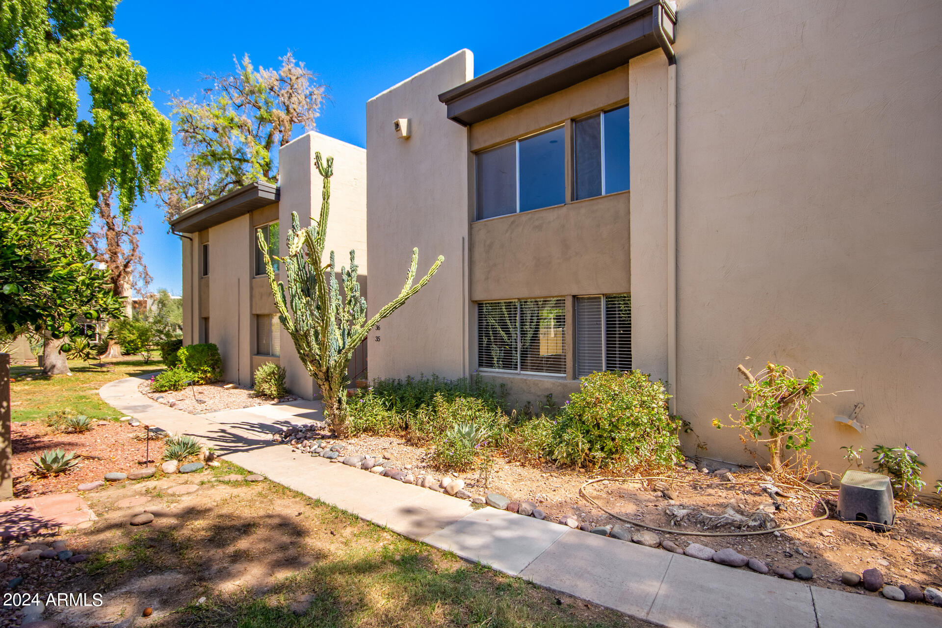 4201 East Camelback Road, Unit 35 Phoenix, AZ 85018 - Photo 7 of 33 a front view of a house with a yard