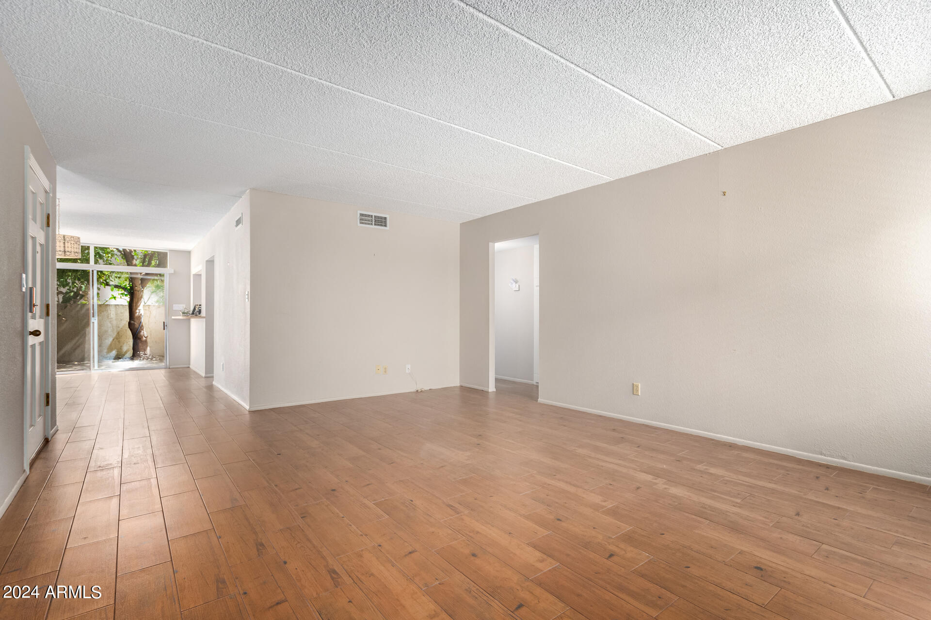 4201 East Camelback Road, Unit 35 Phoenix, AZ 85018 - Photo 9 of 33 a view of a hallway with wooden floor
