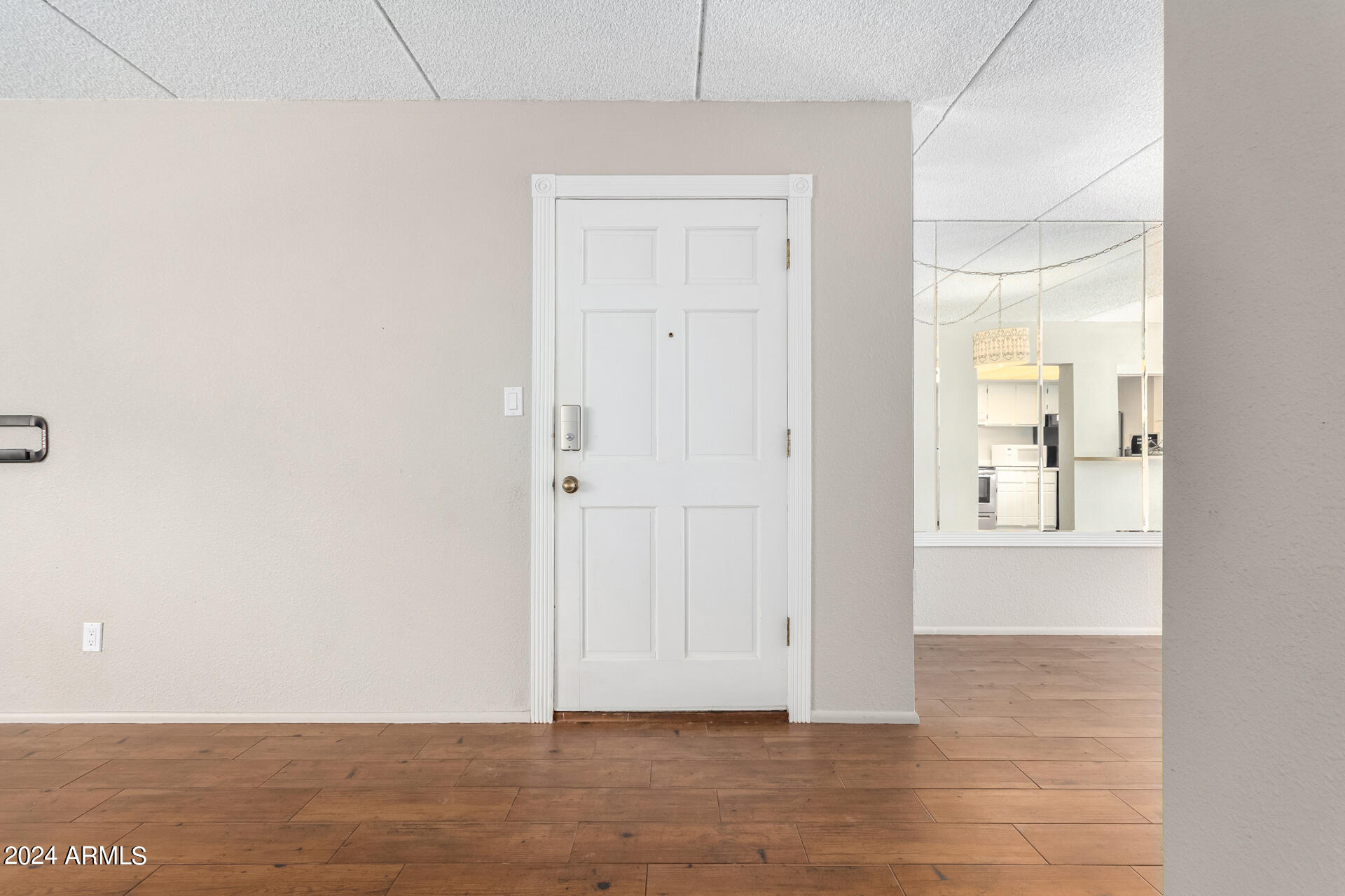 4201 East Camelback Road, Unit 35 Phoenix, AZ 85018 - Photo 10 of 33 an empty room with wooden floor and windows