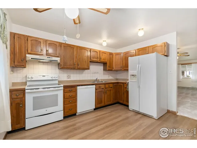 a kitchen with stainless steel appliances granite countertop a refrigerator sink and cabinets