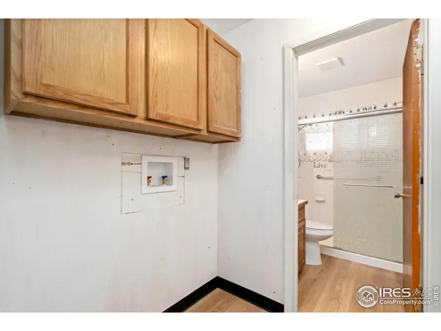 a view of kitchen with granite countertop cabinets and refrigerator