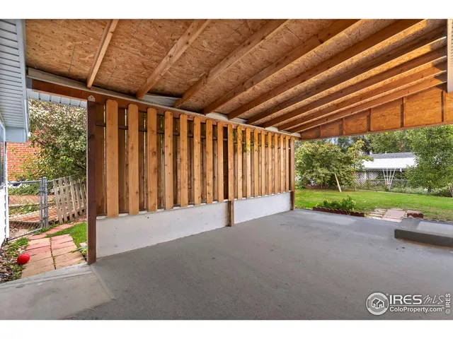 a view of a backyard with wooden fence