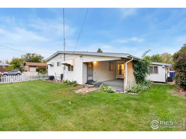 a backyard of a house with table and chairs