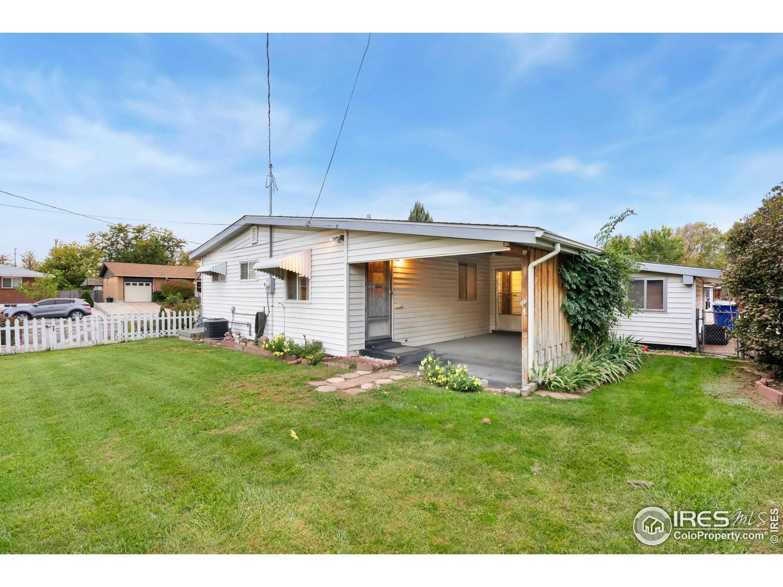 2046 26th Street Road Greeley, CO 80631 - Photo 27 of 34 a backyard of a house with table and chairs