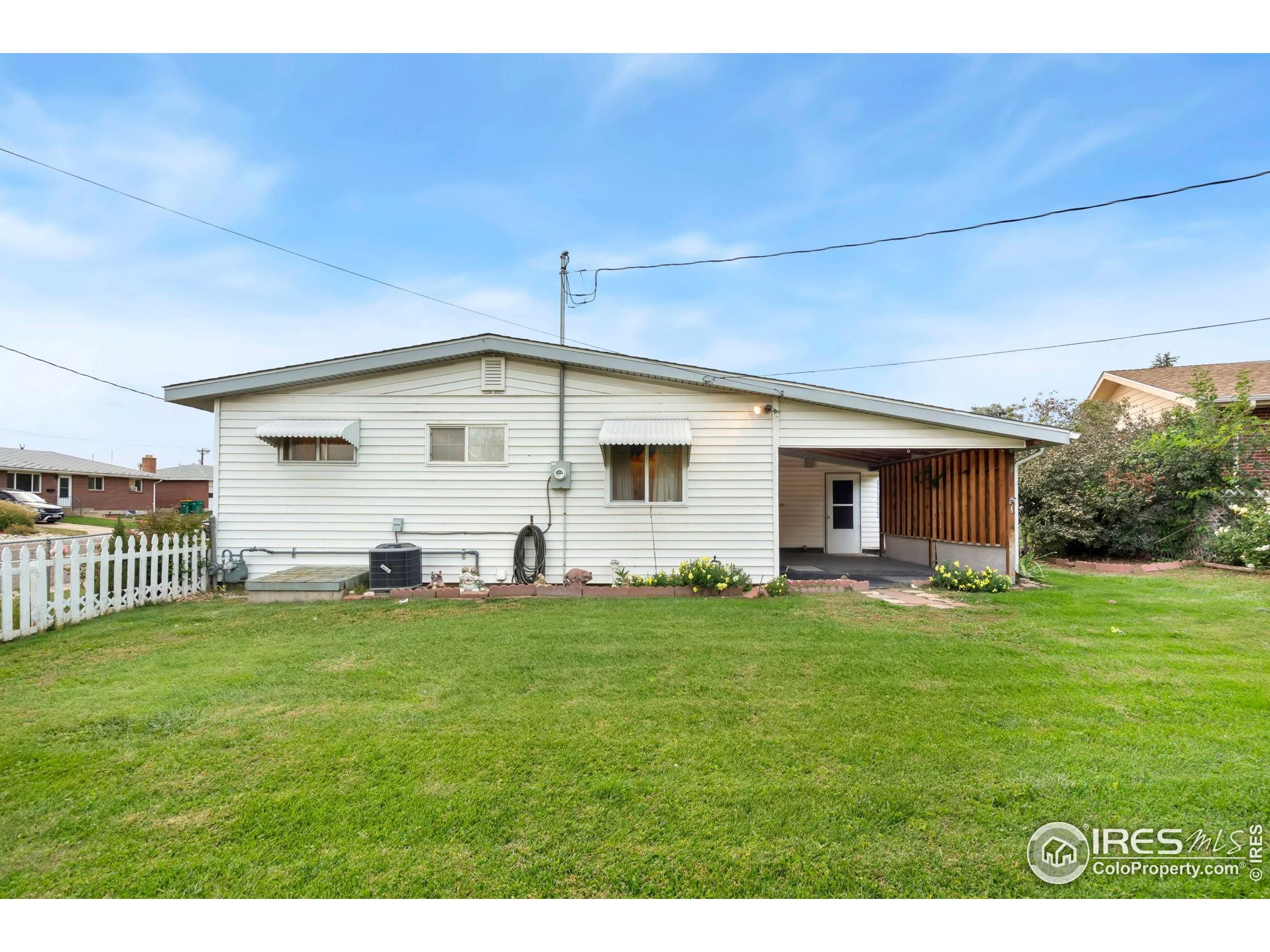 2046 26th Street Road Greeley, CO 80631 - Photo 28 of 34 a front view of a house with a garden