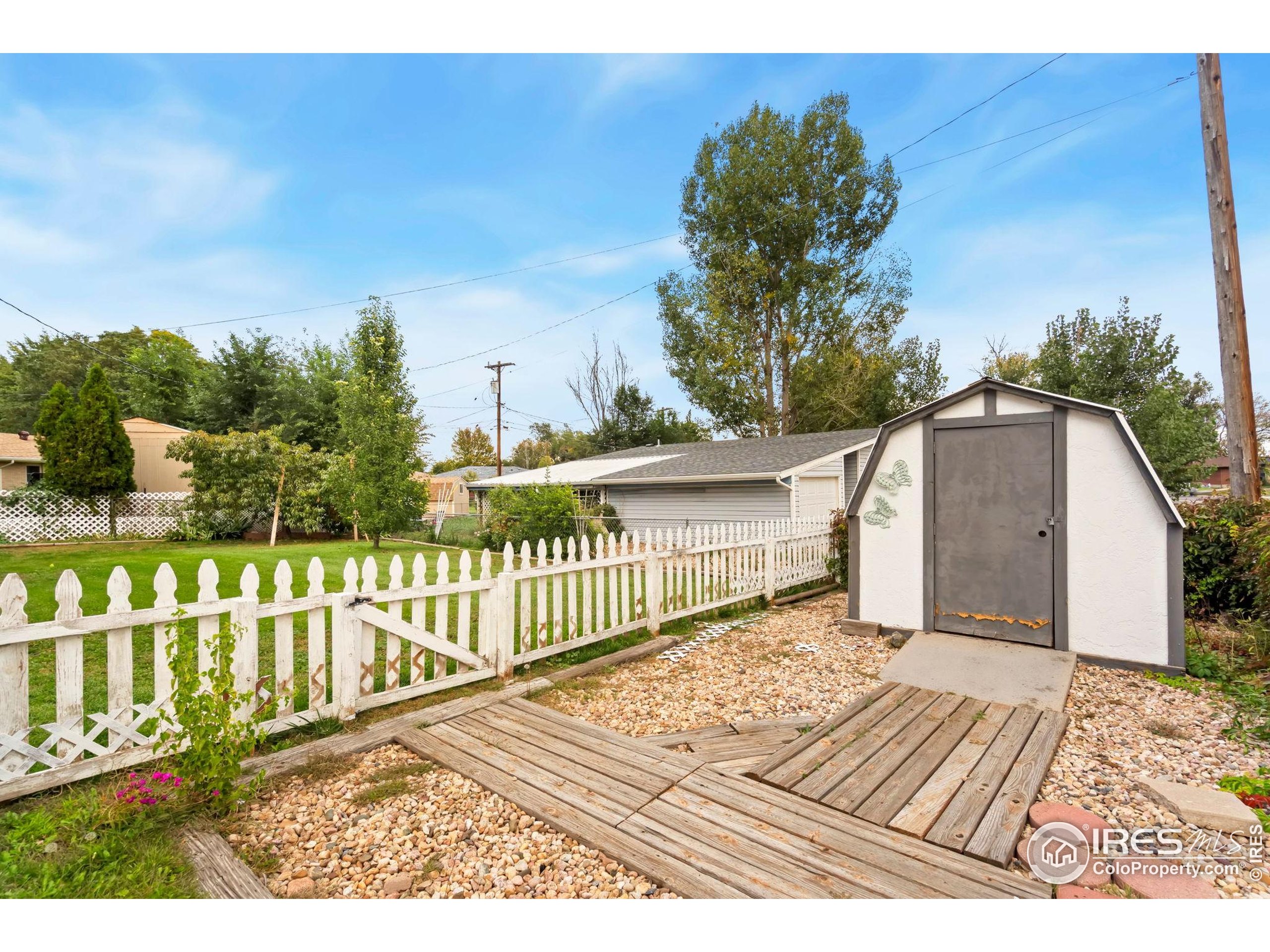 2046 26th Street Road Greeley, CO 80631 - Photo 29 of 34 a view of a balcony with wooden floor and fence