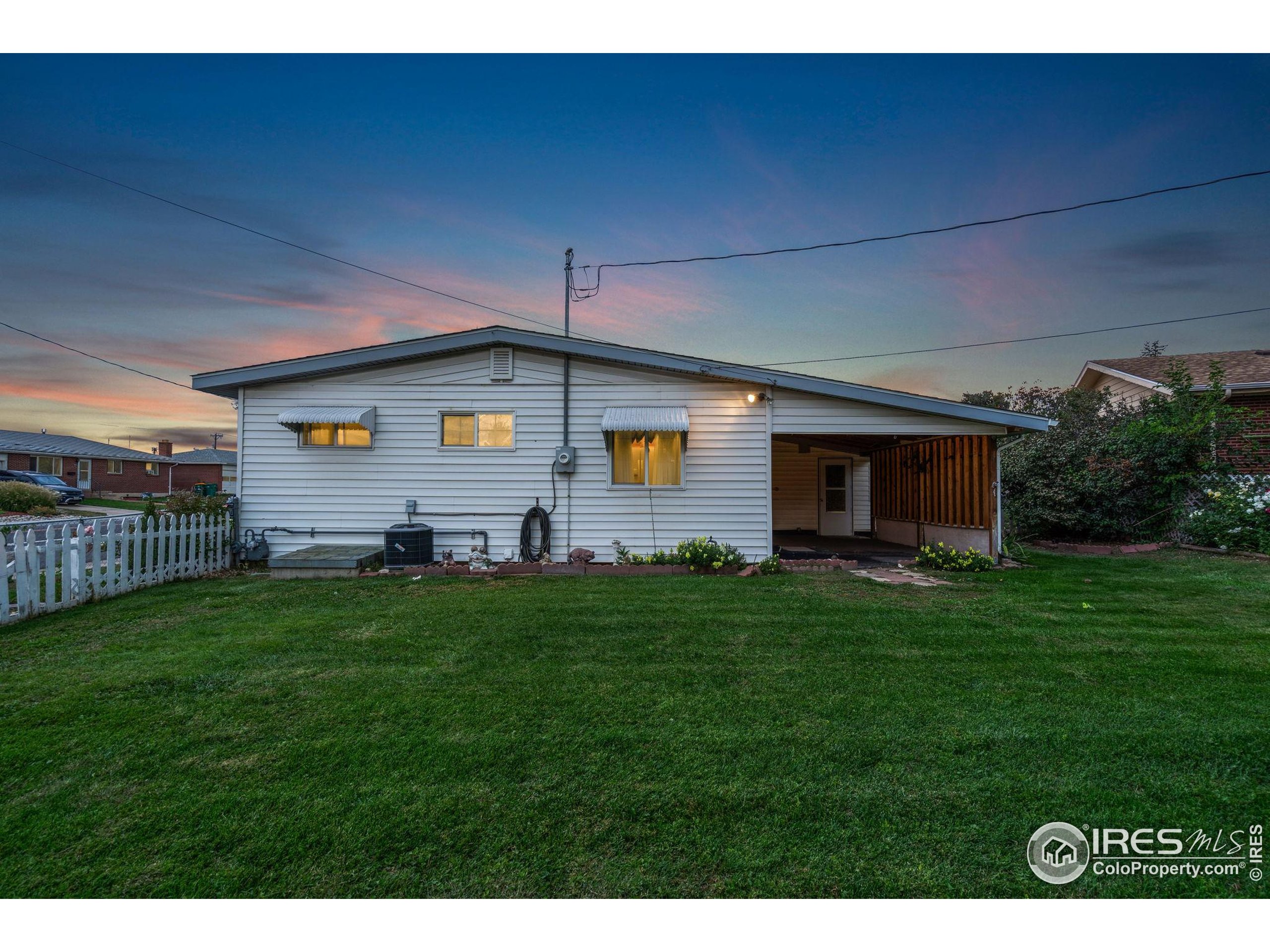 2046 26th Street Road Greeley, CO 80631 - Photo 31 of 34 a view of a backyard with plants and a garden