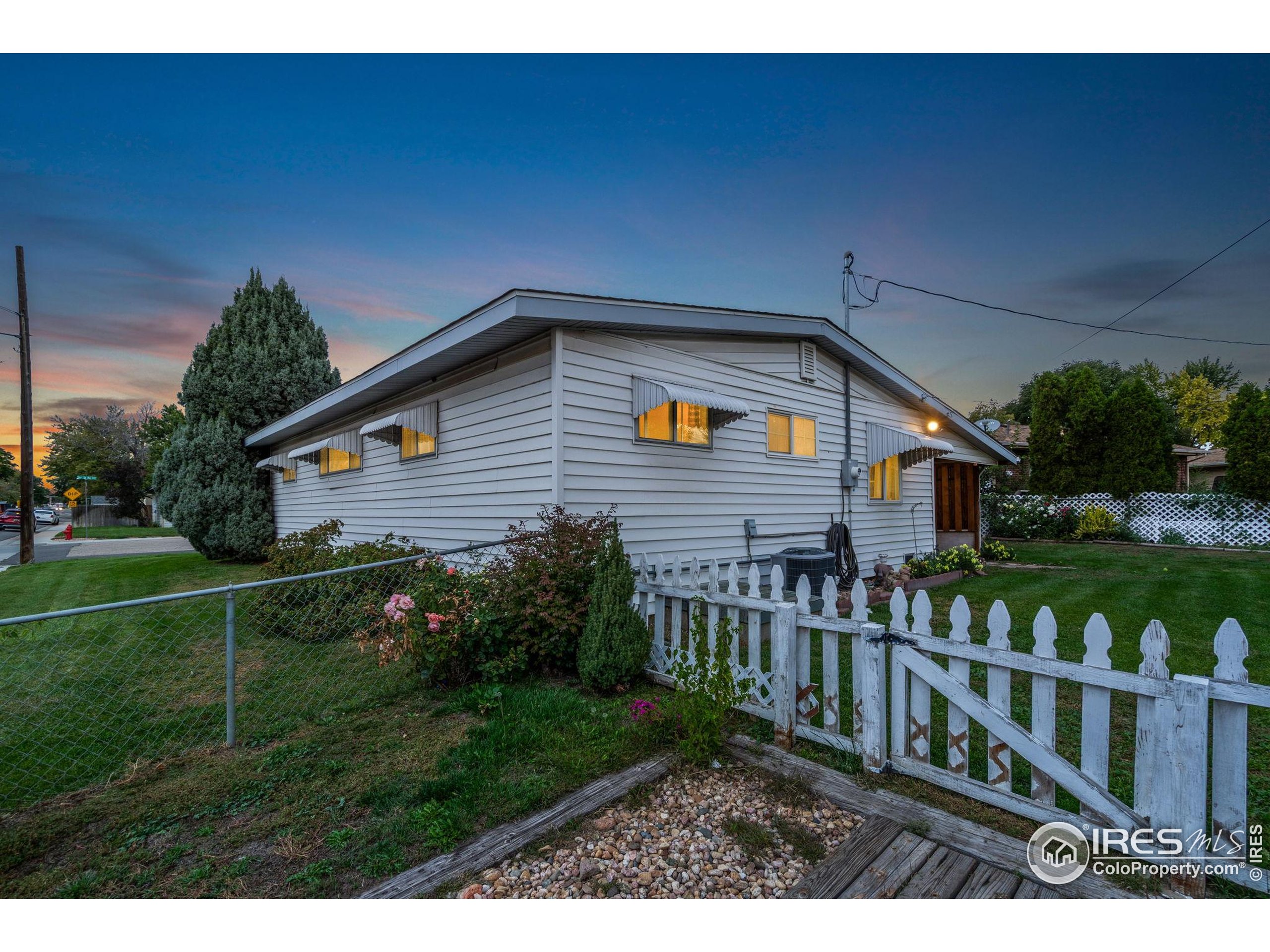 2046 26th Street Road Greeley, CO 80631 - Photo 32 of 34 a front view of house with yard and green space