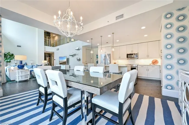 a view of a dining room with furniture and chandelier