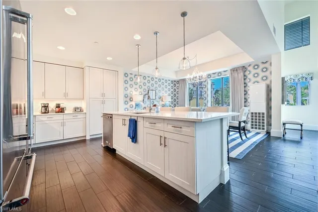 a kitchen with a sink window and stainless steel appliances