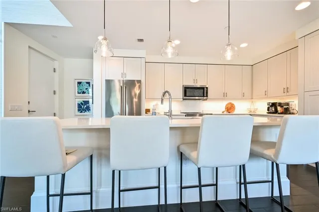 a kitchen with kitchen island cabinets and chair