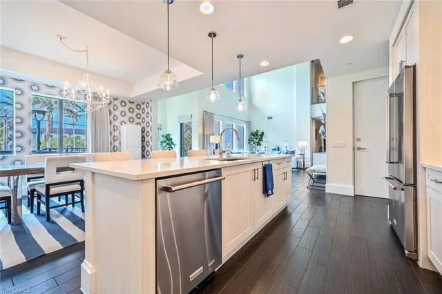 a kitchen with counter top space a sink appliances and wooden floor