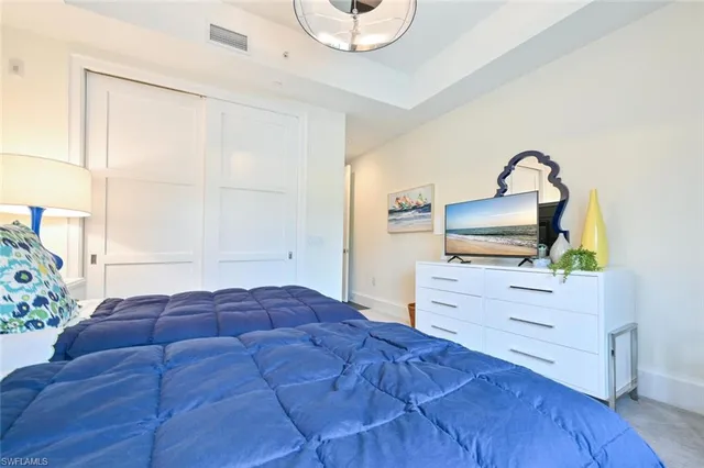 a bedroom with a bed and a dresser