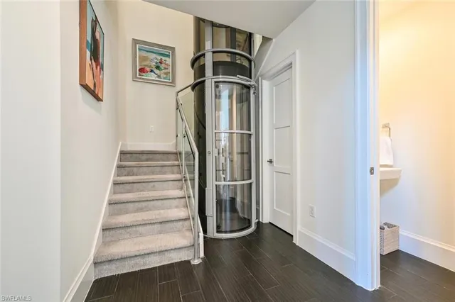 a view of a hallway with wooden floor and entryway