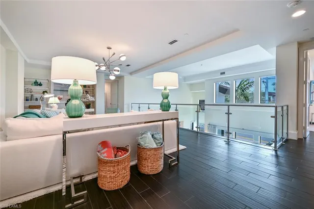 a living room with kitchen island furniture and a chandelier