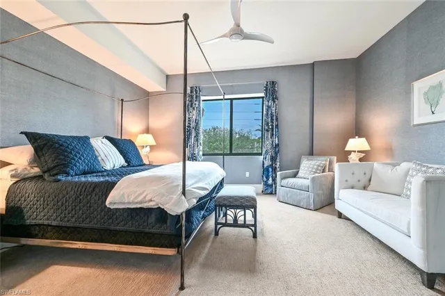 a bedroom with a bed and large window