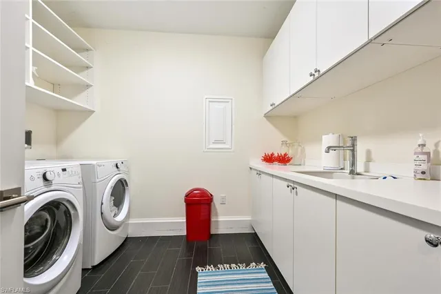 a utility room with sink dryer and washer