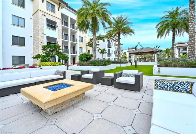 a view of a house with swimming pool and sitting area