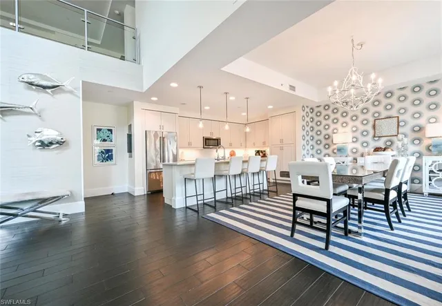 a living room with lots of wooden furniture and a chandelier