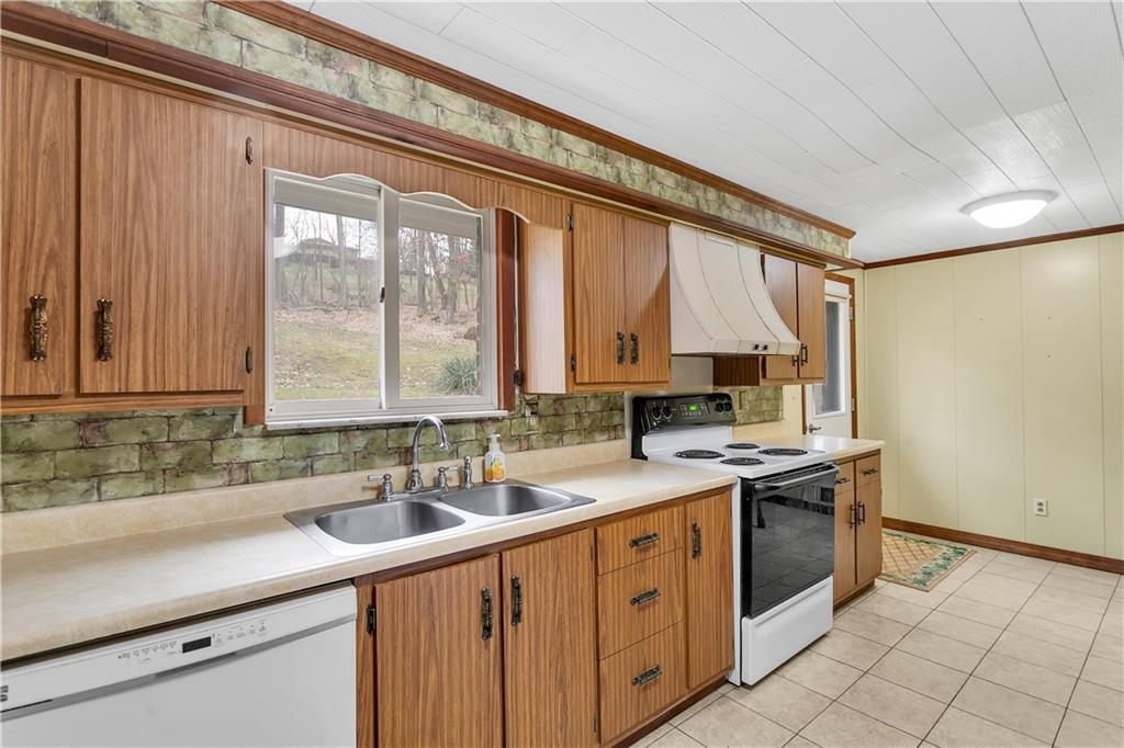 306 Ridgeway Drive Baden, PA 15005 - Photo 13 of 25 a kitchen with a sink stove and cabinets