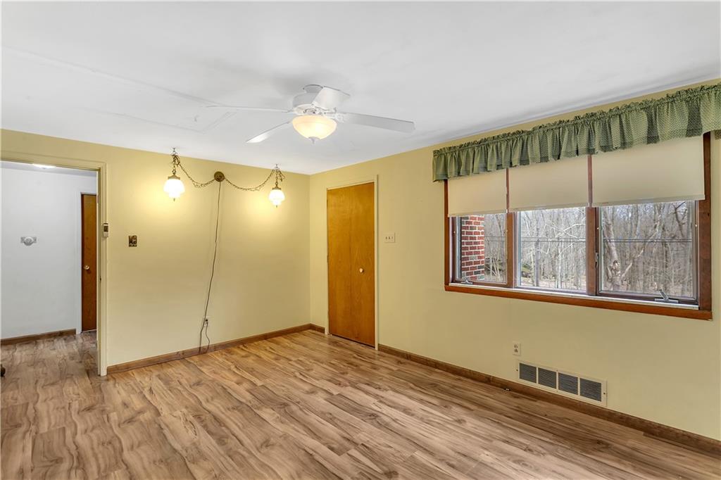306 Ridgeway Drive Baden, PA 15005 - Photo 17 of 25 a view of an empty room with wooden floor and a window