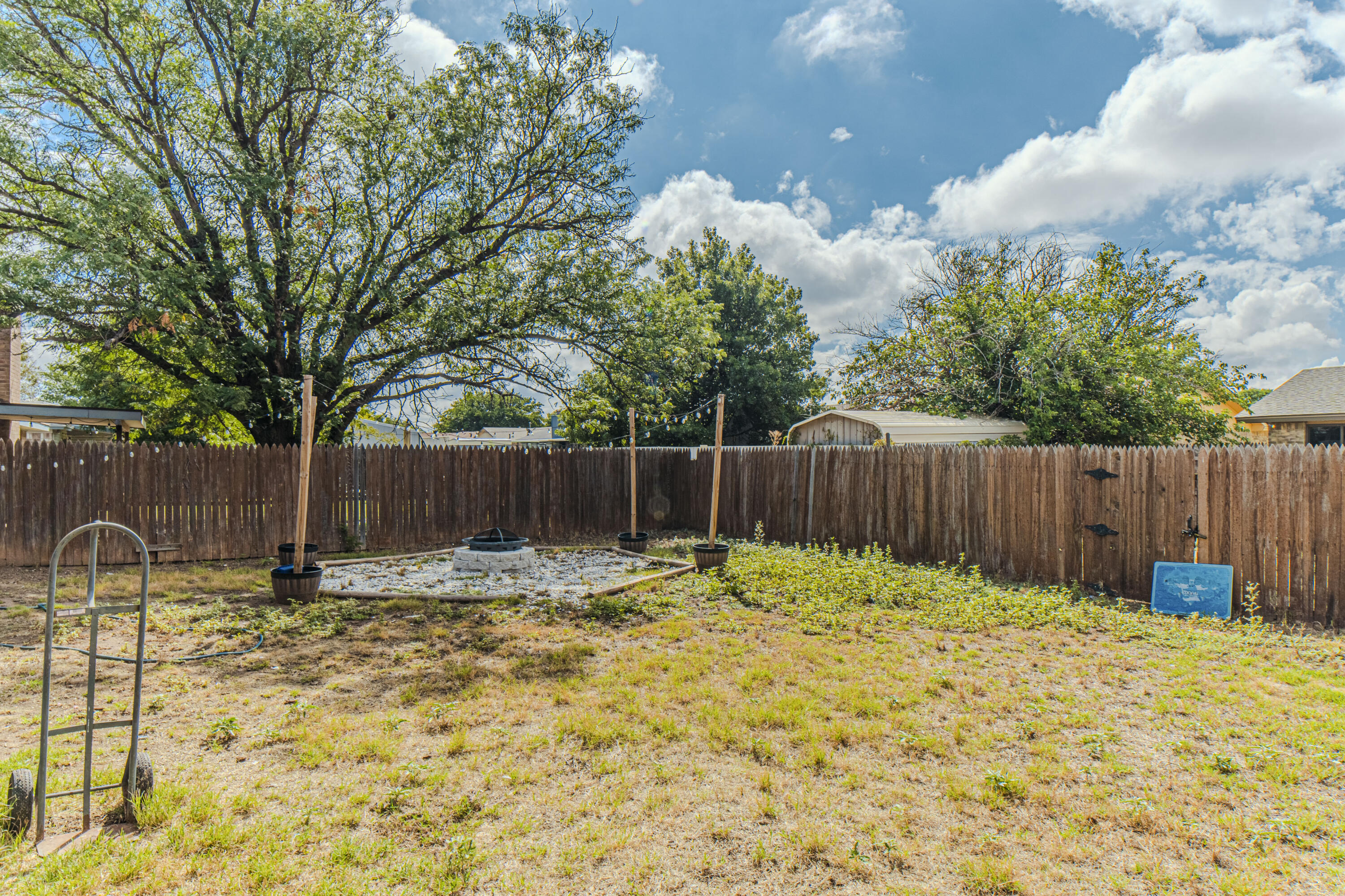 6015 14th Street Lubbock, TX 79416 - Photo 22 of 24 a backyard of a house with table and chairs