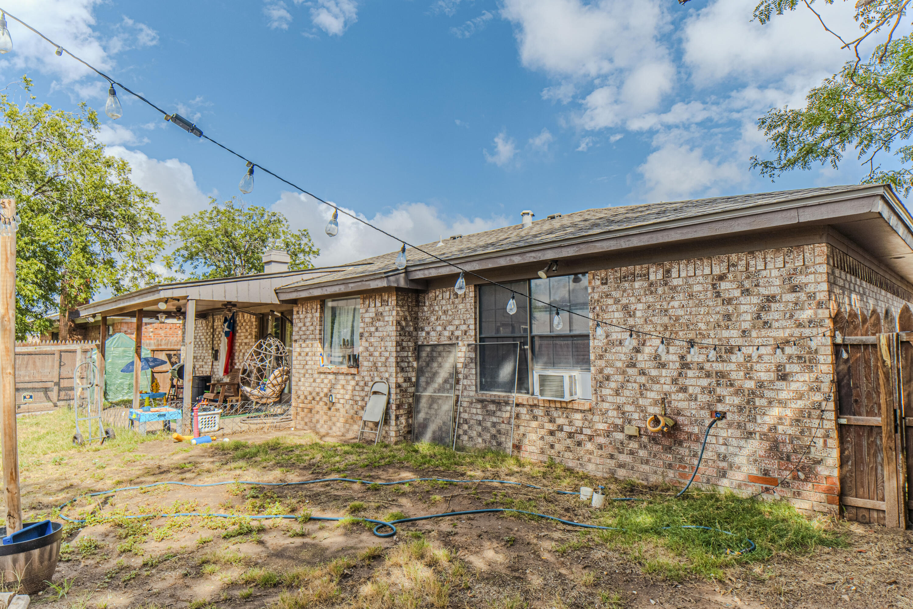 6015 14th Street Lubbock, TX 79416 - Photo 24 of 24 a backyard of a house with table and chairs