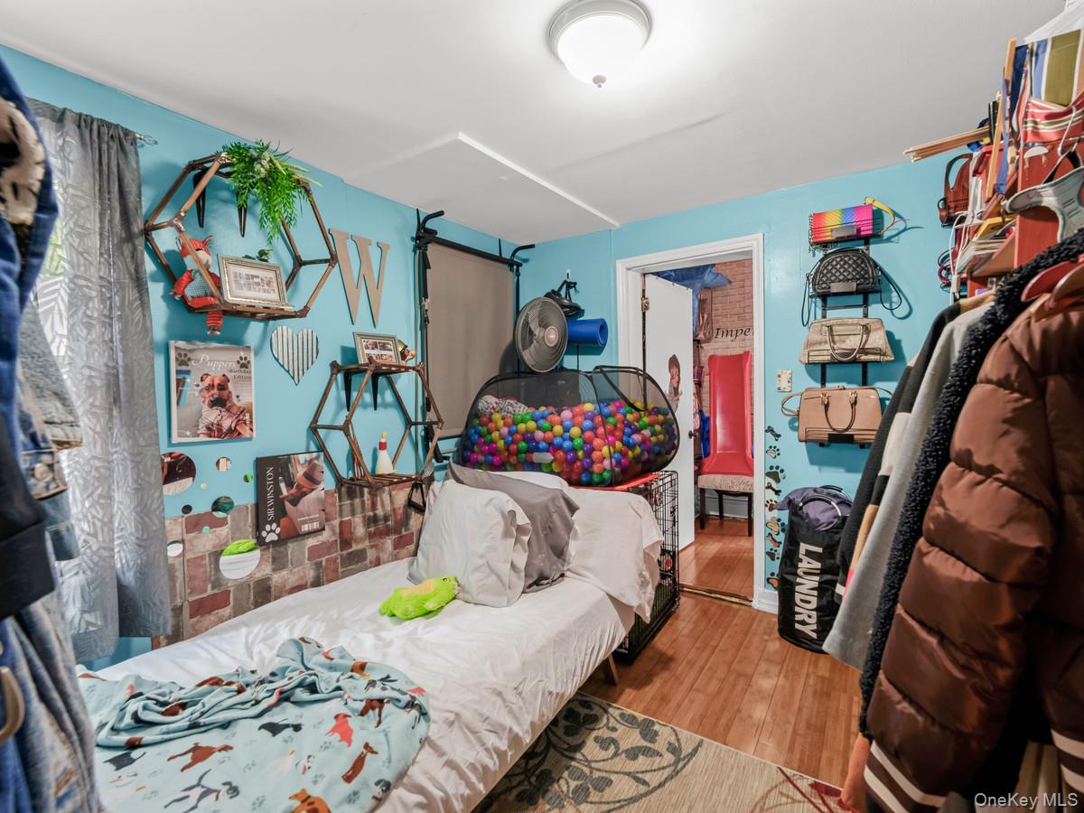218-12 141st Road Queens, NY 11413 - Photo 8 of 14 a bedroom with bed and a wooden floor