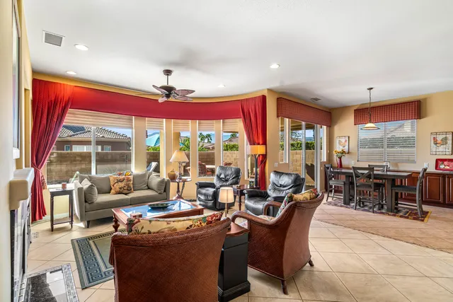 a living room with furniture fireplace and window