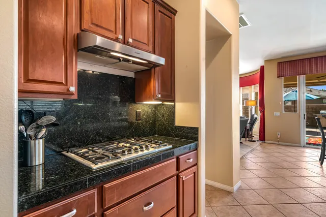 a bedroom with a bed a mirror and paintings on the wall