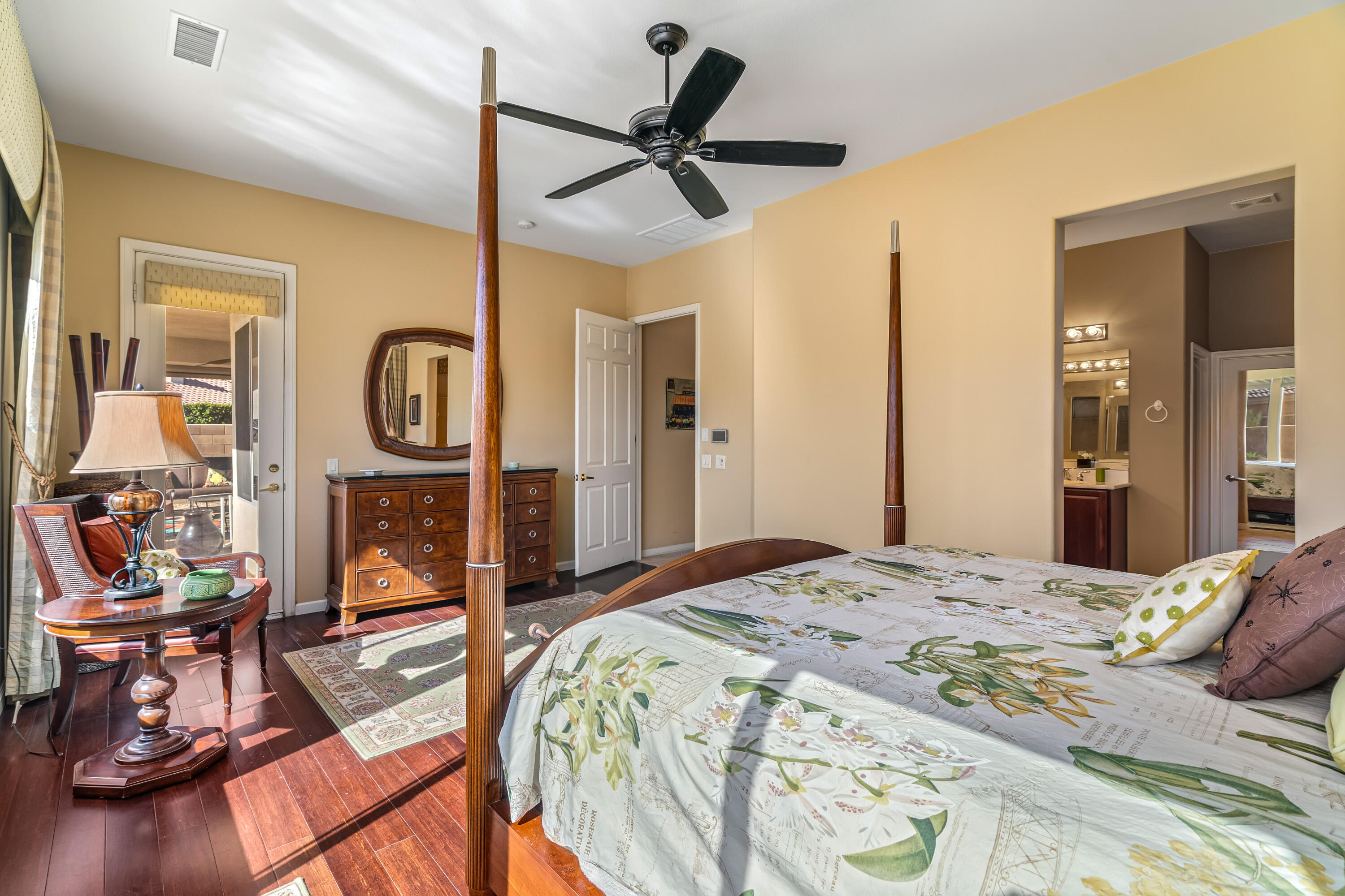 80607 Prestwick Place Indio, CA 92201 - Photo 28 of 68 a bedroom with a bed a mirror and paintings on the wall