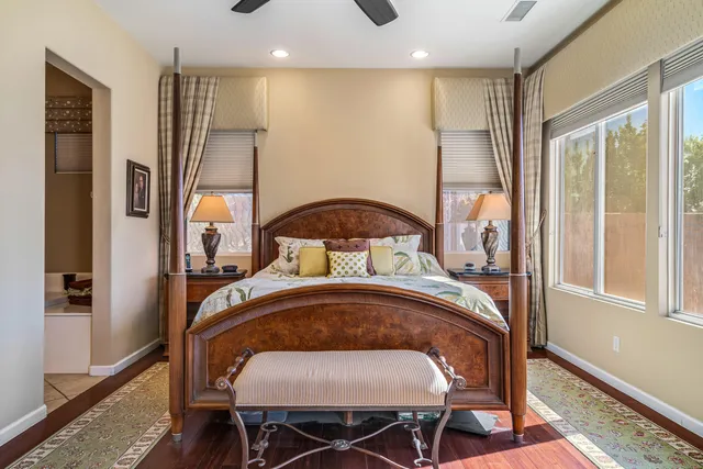 a spacious bathroom with a tub sink and mirror