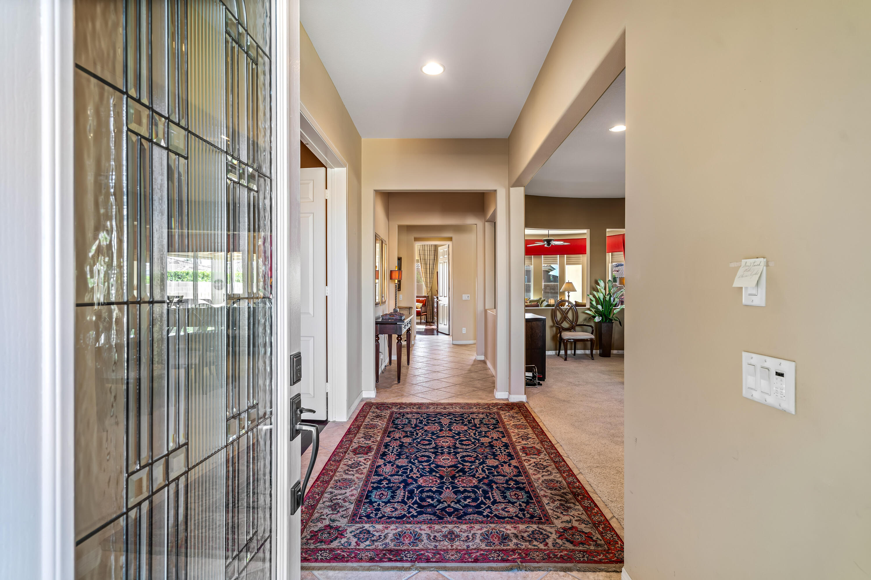 80607 Prestwick Place Indio, CA 92201 - Photo 7 of 68 a view of a hallway with wooden floor and windows