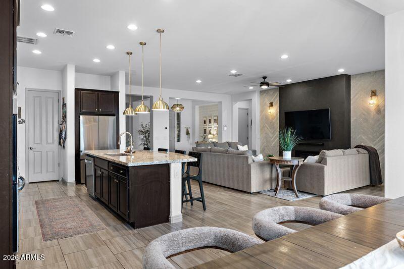 7871 South Stuart Avenue Gilbert, AZ 85298 - Photo 13 of 77 a living room with furniture flat screen tv and kitchen view
