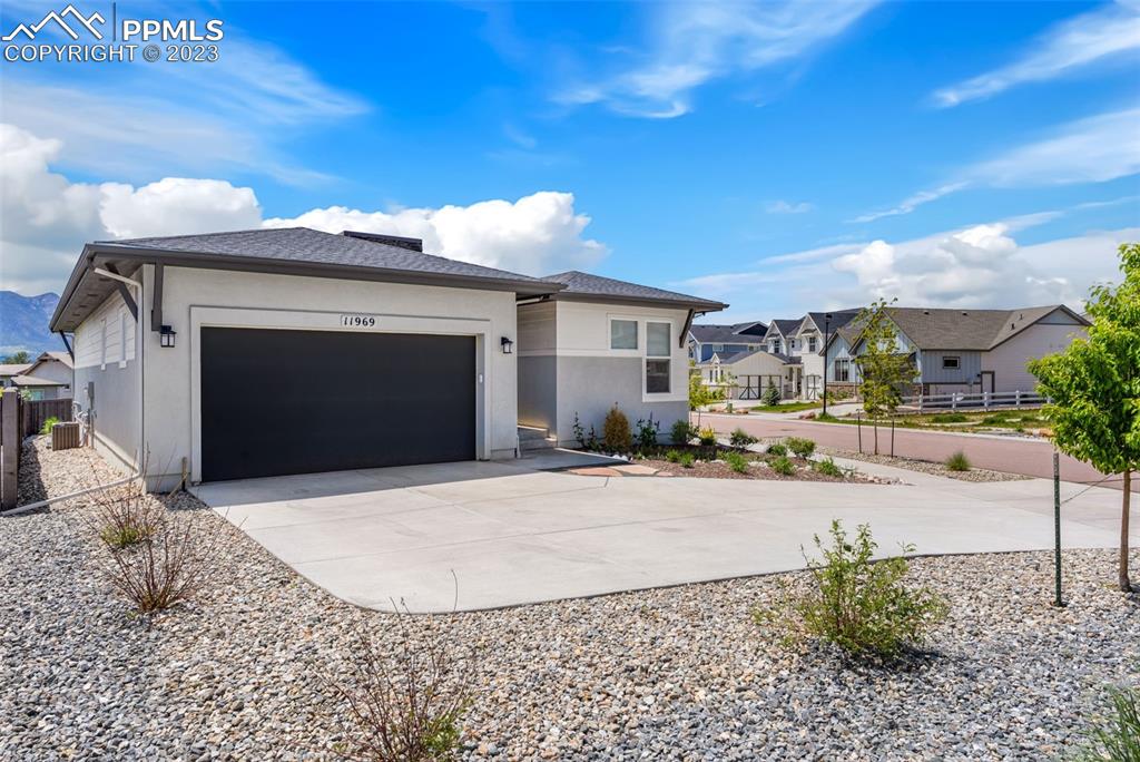 11969 Alydar Loop Colorado Springs, CO 80921 - Photo 2 of 39 a front view of a house with a yard