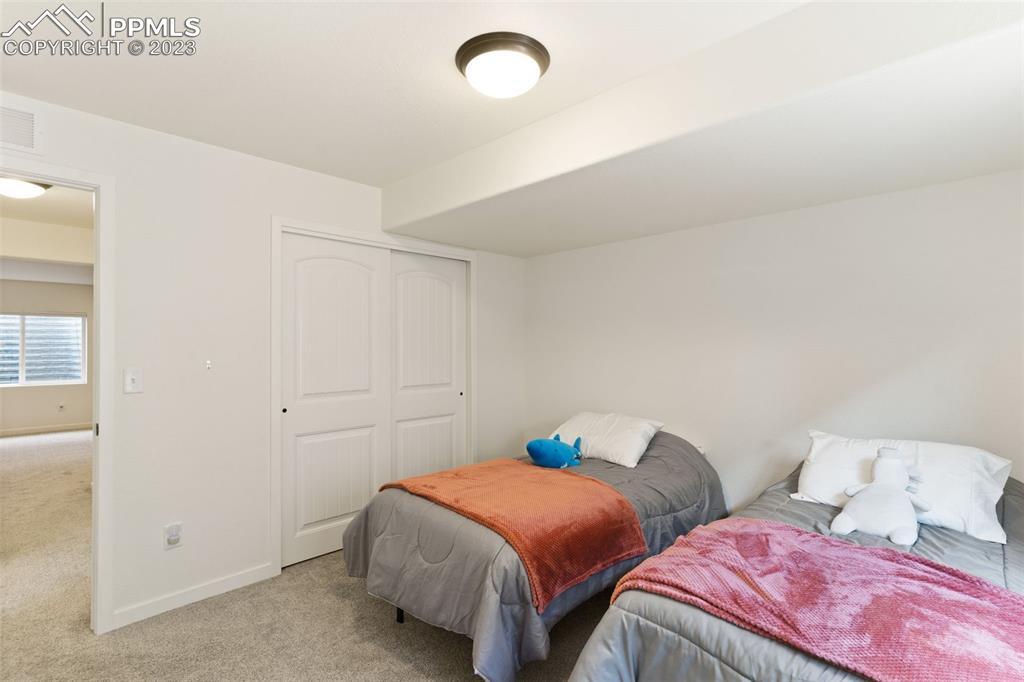 11969 Alydar Loop Colorado Springs, CO 80921 - Photo 26 of 39 a bedroom with two beds and painted walls